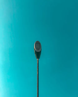 Low angle view of street light against blue sky