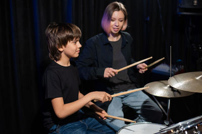 Boy playing drum during performance