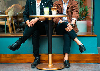 Low section of man sitting on bench