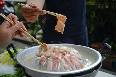 Thailand style bbq grill on a charcoal fire that is located on the bottom with pork, shrimp, squid 