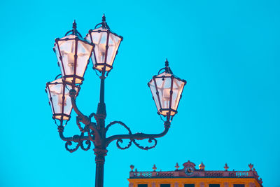 Baroque street light against blue sky . street lamps near castle