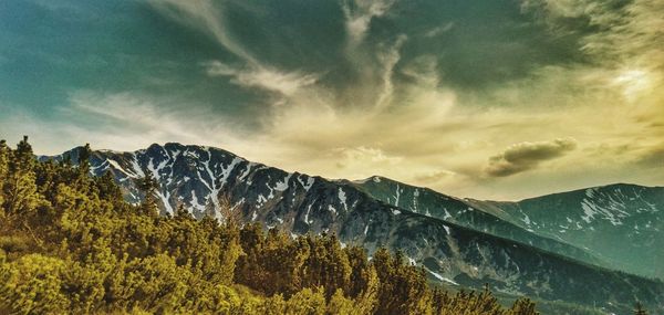 Scenic view of mountains against cloudy sky