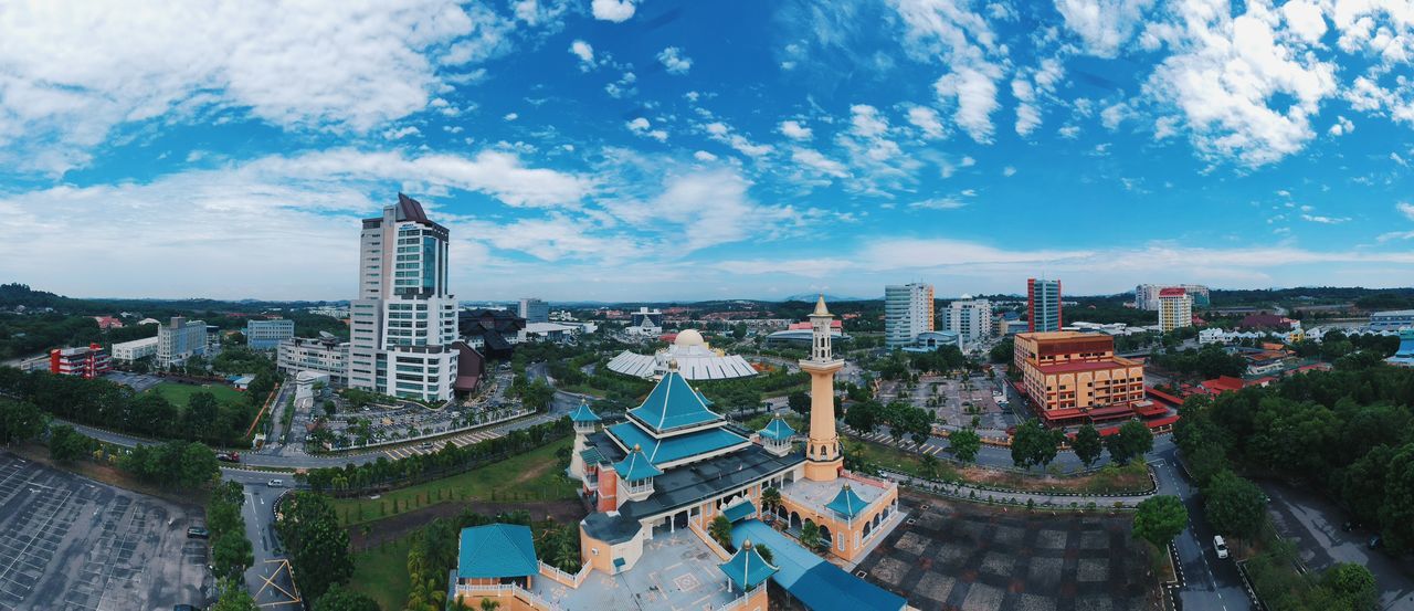 Urban skyline ferris wheel sky outdoors cloud - sky building exterior no people skyscraper day mosque architecture