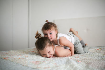 Sister's girls play and hug, emotions. concept childhood and related relationships, lifestyle 