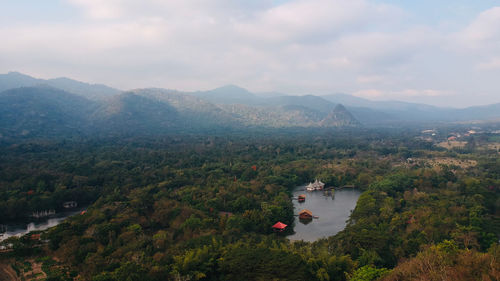 High angle view of townscape by mountains against sky