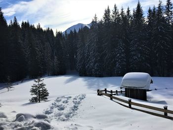 Scenic view of snow covered field against sky