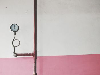 Close-up of clock mounted on wall