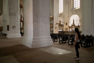 Low section of woman sitting in church
