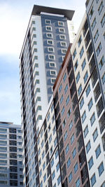 Low angle view of modern buildings in city against sky