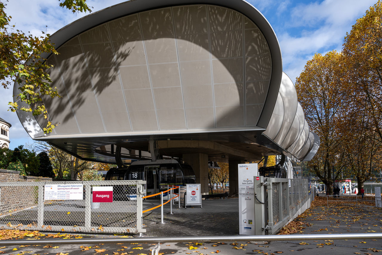 architecture, transport, built structure, transportation, nature, urban area, tree, building exterior, sky, city, stadium, sport venue, plant, day, no people, outdoors, road, street