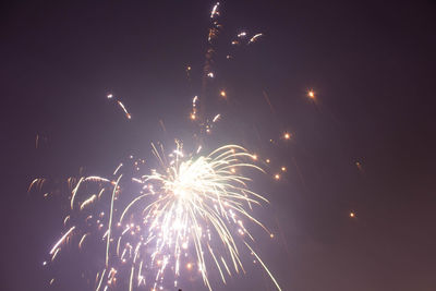 Low angle view of firework display at night