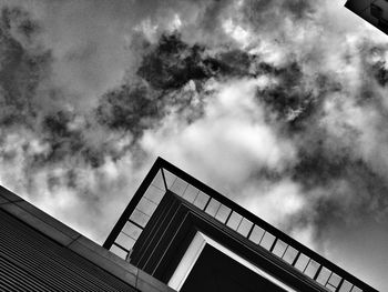 Low angle view of building against cloudy sky