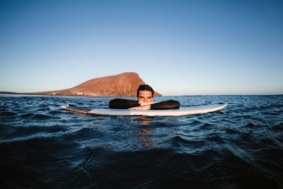 Portrait of man in sea against clear sky