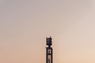 Low angle view of communications tower against clear sky