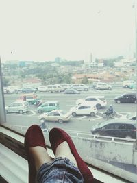 Low section of woman relaxing on tiled floor