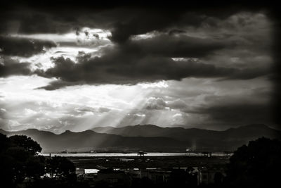 Panoramic view of city against cloudy sky