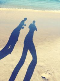Shadow of people on beach