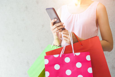 Midsection of woman using mobile phone