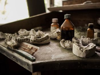 Close-up of dentures and bottles on table