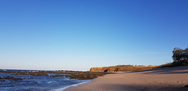 Scenic view of sea against clear blue sky