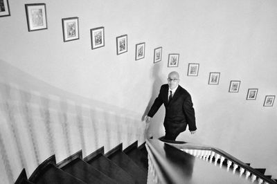 High angle portrait of man climbing on steps