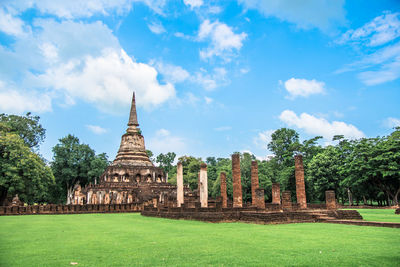 Temple by building against sky