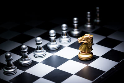 High angle view of chess pieces on board