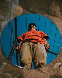 Rear view of boy standing on floor