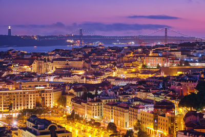 High angle view of illuminated cityscape against sky at night