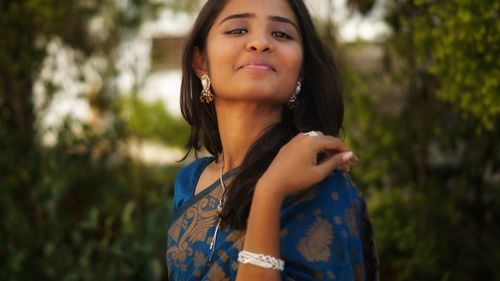 Portrait of beautiful young woman looking away