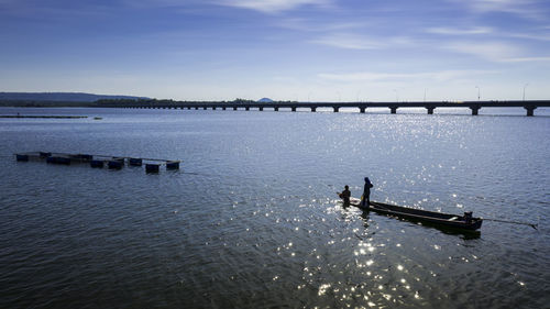 Fishermen in the lam pao dam, the thepsuda bridge. bueng kan. thailand 30 oct 2019