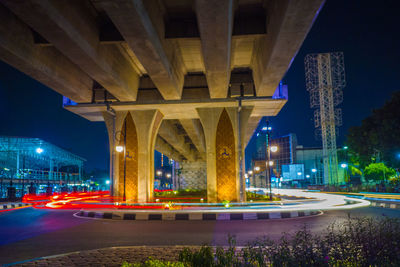 Illuminated bridge over city at night