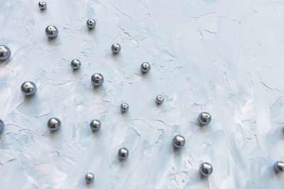 Black pearls on blue creative abstract backround. flat lay, top view, social media hero header