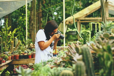 Woman working in greenhouse