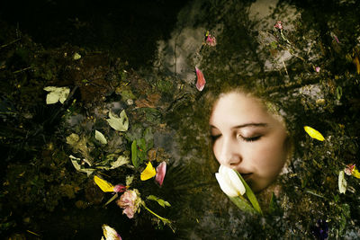 Young woman submerged in a pond