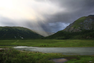 Scenic view of lake and mountains against sky