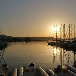 Sailboats moored at harbor