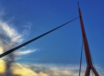 Low angle view of power lines against blue sky