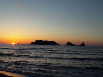 Scenic view of sea against clear sky during sunset