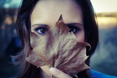 Close up of woman holding leaf