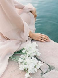 Midsection of woman with flower bouquet