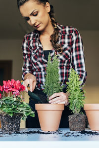 Young woman with potted plants