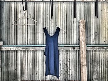 Close-up of clothes hanging on metal wall