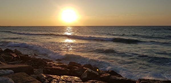 Scenic view of sea against sky during sunset