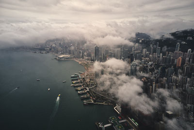 High angle view of buildings by sea against sky