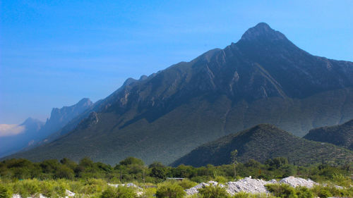 Scenic view of mountains against clear blue sky