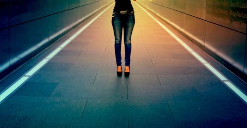 Low section of people walking on tiled floor