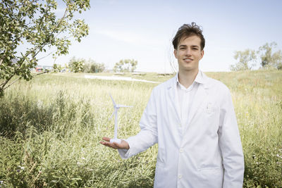 Portrait of young man standing on field