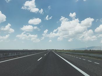 Empty road against cloudy sky