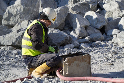 Man working on rock